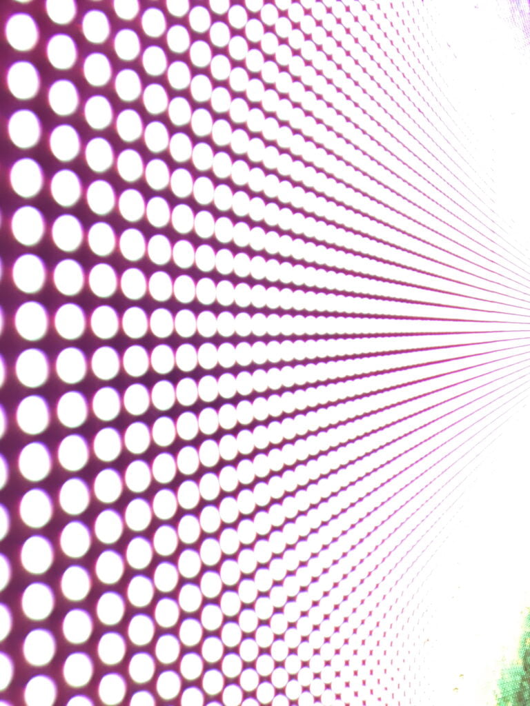 Background of colorful luminous circles, close-up of a led screen.